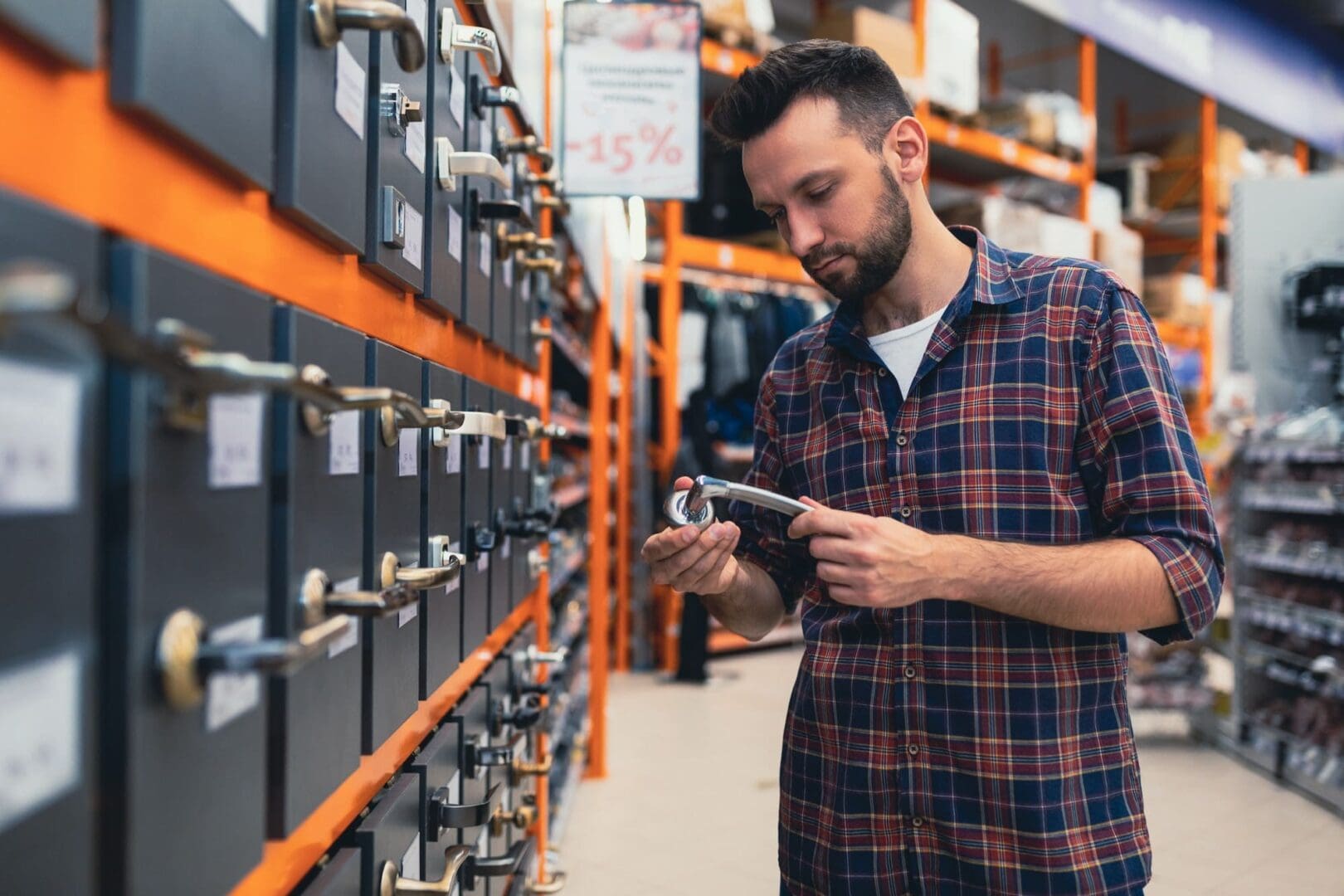 a man chooses a doorknob in a hardware store.