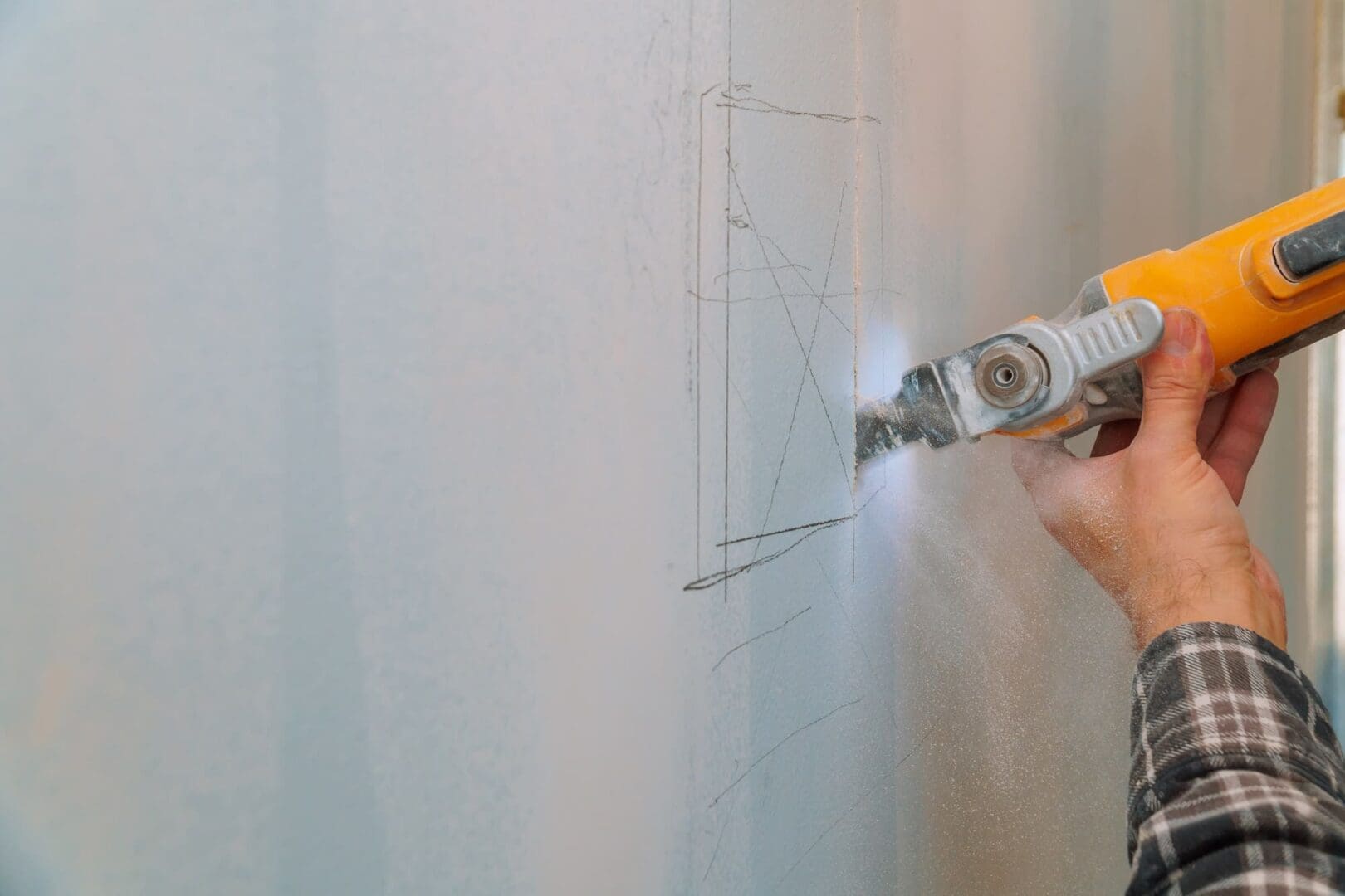 Cutting plasterboard plaster drywall hand with electro saw