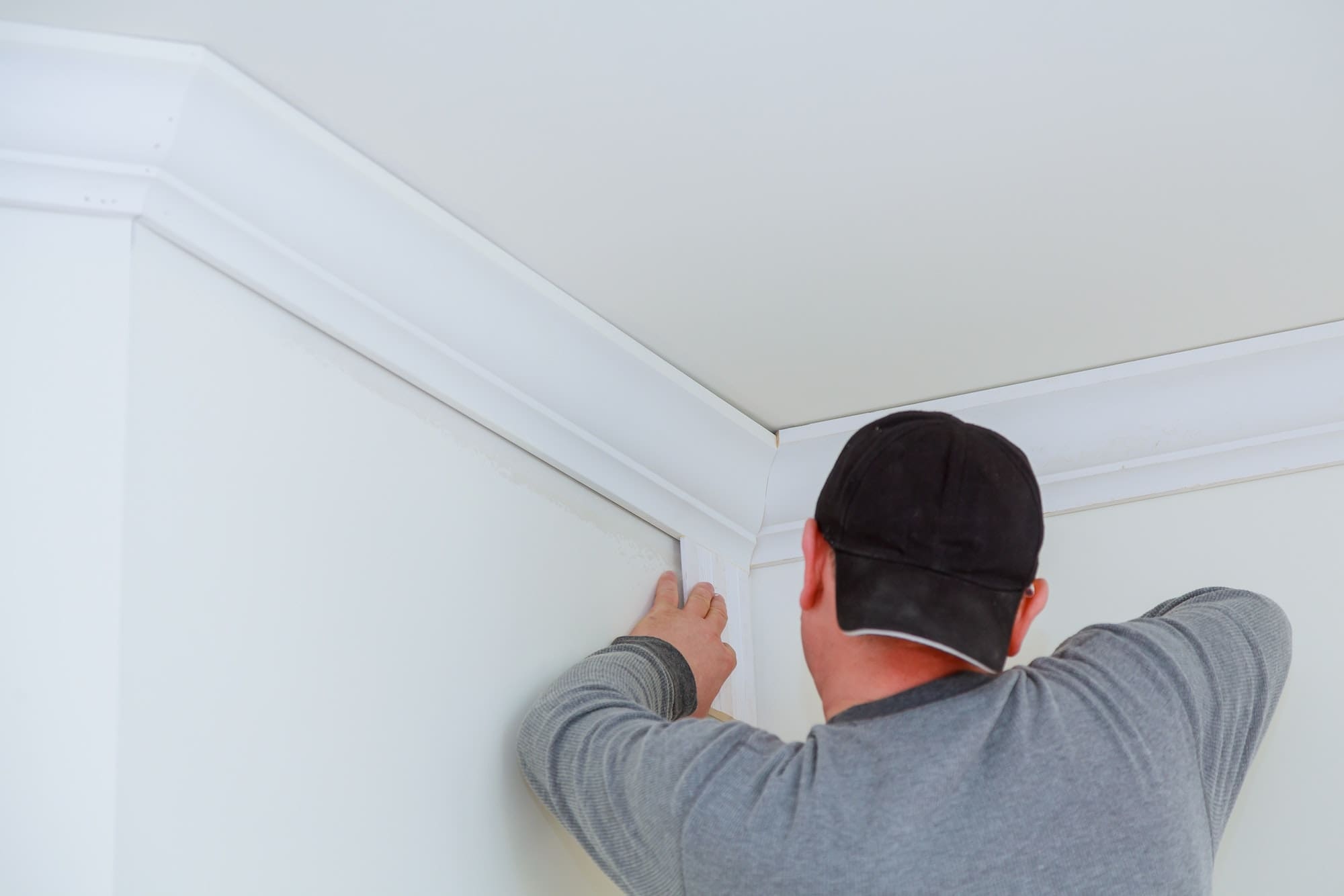 Installation of ceiling on detail of intricate corner crown molding