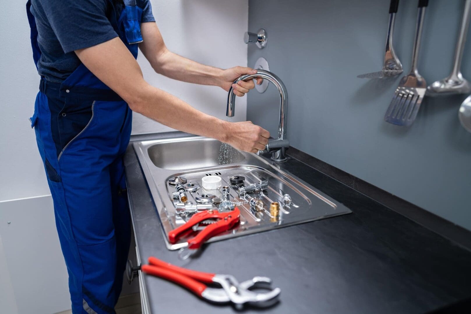 kitchen sink install Concept, Creative Photo About Plumber installing sink in kitchen interior.